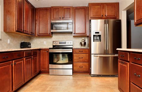 cherry cabinets with black stainless steel appliances|cherry wood kitchen cabinets photos.